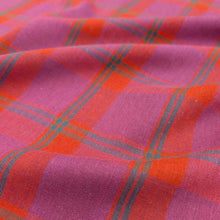 Load image into Gallery viewer, Flat lay of linen cotton Raspberry Plaid in red, pink and purple. Available at Minerva&#39;s Bower. Fabric draped to show how it handles