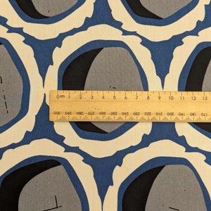 Close up of Rayon with circular grey and black shapes and blue and cream accents, for sale at Minerva's Bower, ruler included for scale