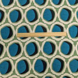 Rayon with circular teal and black shapes and green and cream accents, for sale at Minerva's Bower, ruler included for scale