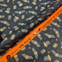 Load image into Gallery viewer, Pattern of bats and moon phases on a dark blue cotton Ruby Star Society fabric background. Made in Japan. Available at Minerva's Bower. Fabric draped to show how it handles