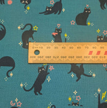 Load image into Gallery viewer, Pattern of black cats with flowers on a teal cotton Ruby Star Society fabric background. Made in Japan. Available at Minerva's Bower. Ruler included for scale