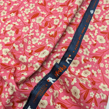 Load image into Gallery viewer, Floral pattern with red and white flowers on a pink cotton background. Made in Japan. Available at Minerva's Bower. Fabric draped to show how it handles