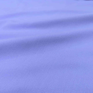 Flat lay of Sonnor stretch cotton Twill in lilac. Available at Minerva's Bower. Fabric is draped to show how it handles