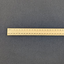 Load image into Gallery viewer, Flat lay of black Sonnor stretch cotton Twill. Available at Minerva&#39;s Bower. Ruler included for scale