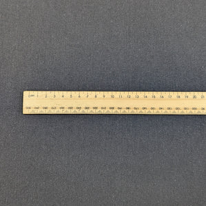 Flat lay of black Sonnor stretch cotton Twill. Available at Minerva's Bower. Ruler included for scale