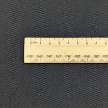 Load image into Gallery viewer, Flat lay of black Sonnor stretch cotton Twill. Available at Minerva&#39;s Bower. Ruler included for scale