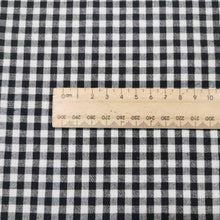 Load image into Gallery viewer, Flat lay of Spencer cotton linen check in black. Available at Minerva&#39;s Bower. Ruler included for scale