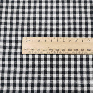 Flat lay of Spencer cotton linen check in black. Available at Minerva's Bower. Ruler included for scale