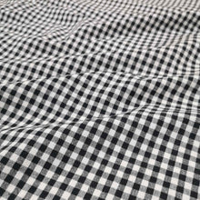 Load image into Gallery viewer, Flat lay of Spencer cotton linen check in black. Available at Minerva&#39;s Bower. Fabric draped to show how it handles