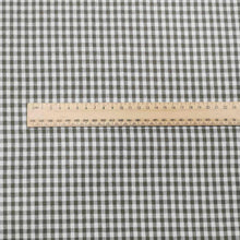 Load image into Gallery viewer, Flat lay of Spencer cotton linen check in olive. Available at Minerva&#39;s Bower. Ruler included for scale