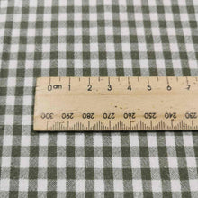 Load image into Gallery viewer, Flat lay of Spencer cotton linen check in olive. Available at Minerva&#39;s Bower. Ruler included for scale