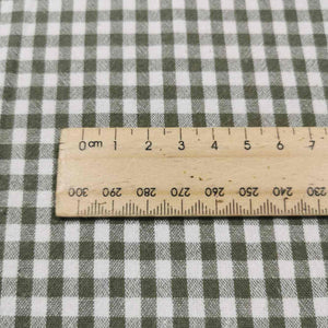 Flat lay of Spencer cotton linen check in olive. Available at Minerva's Bower. Ruler included for scale