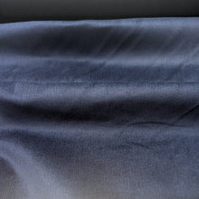Load image into Gallery viewer, Close-up of navy pinwale stretch corduory fabric. Available at Minerva's Bower. Fabric draped to show how it handles