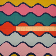 Load image into Gallery viewer, Flat lay of 100% Cotton Poplin Summer Abroad, with a colourful wavy pattern, ruler included for scale - available at Minerva's Bower 