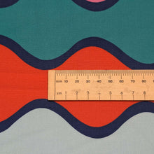 Load image into Gallery viewer, Close up flat lay of 100% Cotton Poplin Summer Abroad, with a colourful wavy pattern, ruler included for scale -  available at Minerva's Bower 
