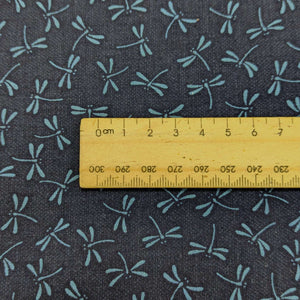 Close up of Japanese 100% Cotton, Tonbo, indigo base with a small dragonfly design, available now at Minerva's Bower and ruler included for scale