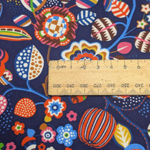 Load image into Gallery viewer, Close up flat lay of Thread and Ink 100% Cotton, Tree Flower Navy Blue cloth with vibrant multicolour retro floral design, ruler included for scale - for sale at Minerva's Bower