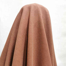 Load image into Gallery viewer, Avery tencel cotton twill has a velvety feel, and soft drape. A warm terracotta brown, available at Minerva&#39;s Bower. Fabric is draped over roll