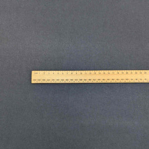 Flat lay of Avery, a heavyweight tencel twill, in a navy colourway. Available at Minerva's Bower. Ruler included for scale