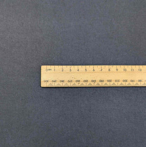 Flat lay of Avery, a heavyweight tencel twill, in a navy colourway. Available at Minerva's Bower. Ruler included for scale