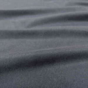 Flat lay of Avery, a heavyweight tencel twill, in a navy colourway. Available at Minerva's Bower. Fabric draped toshow how it handles
