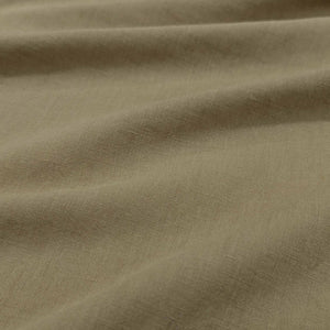 Flat lay of Bella linen cotton in sahara colourway. Available at Minerva's Bower. Fabric draped to show how it handles