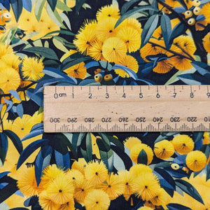 Flat lay of Devonstone cotton in Wattle. Available at Minerva's Bower. Ruler included for scale