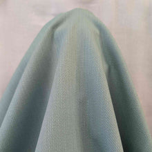 Load image into Gallery viewer, Flat lay of cotton denim, in duck egg colourway. Available at Minerva&#39;s Bower. FAbric draped to show how it handles