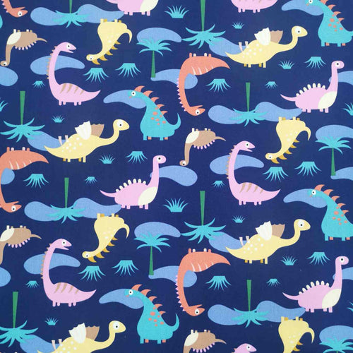 Flat lay of pure cotton poplin in a happy dinosaur design. Available at Minerva's Bower