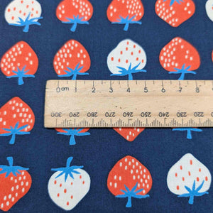 Flat lay of pure cotton, strawberries, by ruby star society. Made in Japan. Available at Minerva's Bower. Ruler included for scale