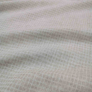 Flat lay of linen cotton dobby check in oatmeal. Available at Minerva's Bower. Fabric draped to show how it handles