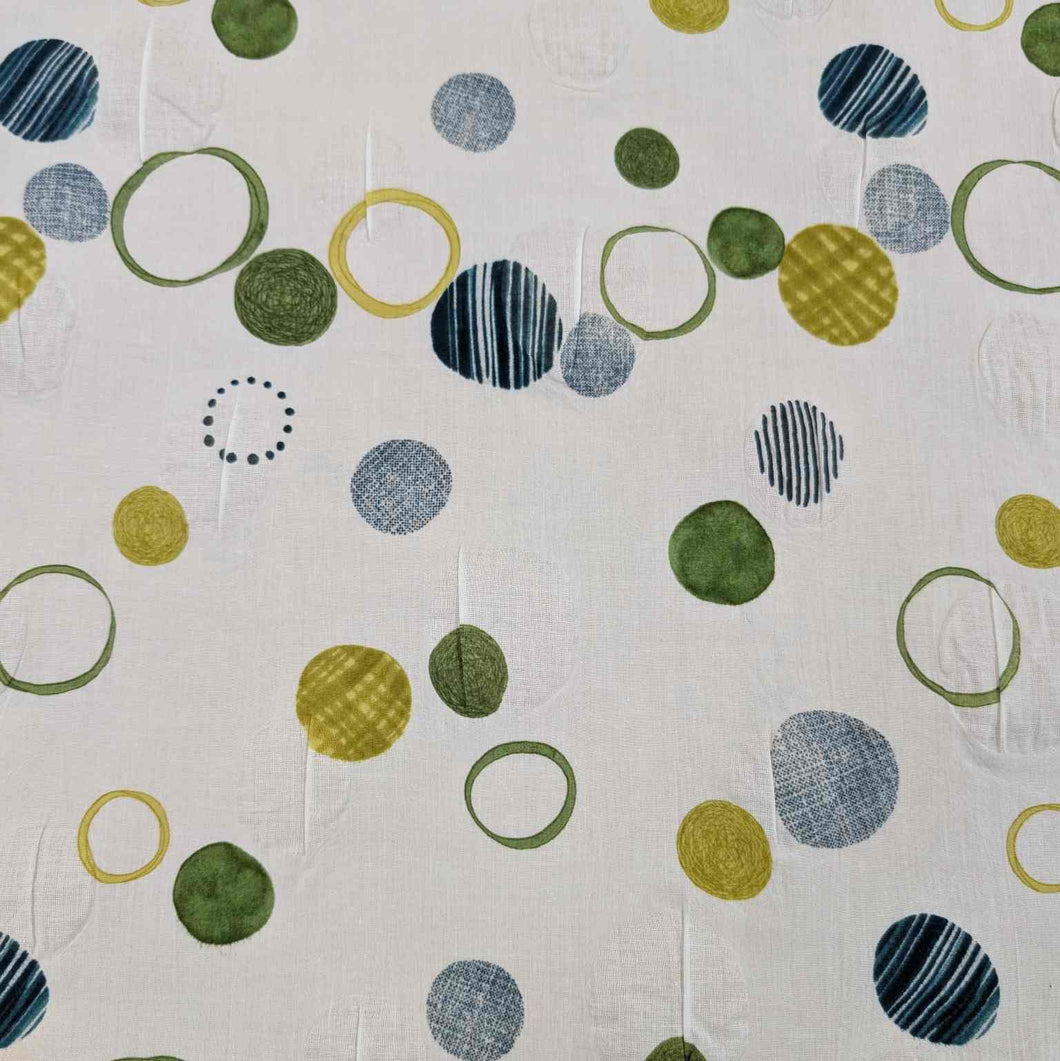 Flat lay of pure cotton seersucker, in green floating circles design. Made in Japan by Kokka. Available at Minerva's Bower