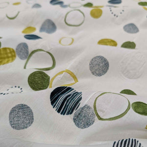 Flat lay of pure cotton seersucker, in green floating circles design. Made in Japan by Kokka. Available at Minerva's Bower.Fabric draped to show how it handles