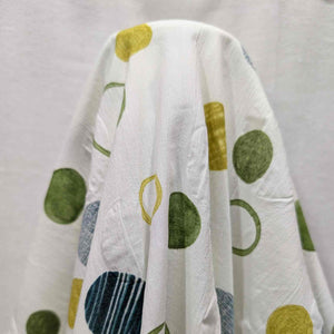 Flat lay of pure cotton seersucker, in green floating circles design. Made in Japan by Kokka. Available at Minerva's Bower.Fabric draped to show how it handles