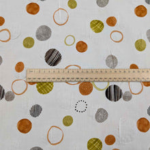 Load image into Gallery viewer, Flat lay of pure cotton seersucker in orange floating circles design. Made in Japan by Kokka. Available at MInerva&#39;s Bower. Ruler included for scale