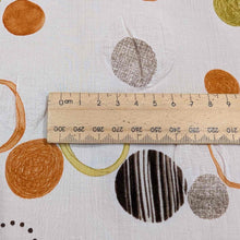 Load image into Gallery viewer, Flat lay of pure cotton seersucker in orange floating circles design. Made in Japan by Kokka. Available at MInerva&#39;s Bower. Ruler included for scale