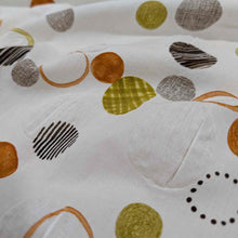 Load image into Gallery viewer, Flat lay of pure cotton seersucker in orange floating circles design. Made in Japan by Kokka. Available at MInerva&#39;s Bower. Fabric draped to show how it handles