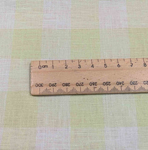 Close up flat lay of Gelato Check - lime linen cotton for sale at Minerva's Bower, with ruler for scale 