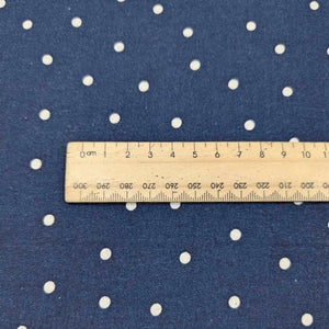 Flat lay of cotton linen spot fabric, in navy colourway. Made in Japan, by Kokka. Available at Minerva's Bower. Ruler included for scale