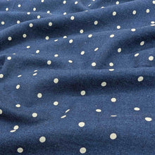 Load image into Gallery viewer, Flat lay of cotton linen spot fabric, in navy colourway. Made in Japan, by Kokka. Available at Minerva&#39;s Bower. Fabric draped to show how it handles