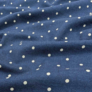 Flat lay of cotton linen spot fabric, in navy colourway. Made in Japan, by Kokka. Available at Minerva's Bower. Fabric draped to show how it handles