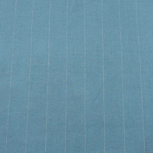 Flat lay of pure linen twill in amalfi blue with white stripes. Available at Minerva's Bower