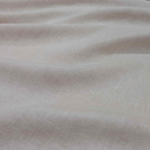 Flat lay of pure linen in a ballet colourway. Available at Minerva's Bower. Fabric draped to show how it handles