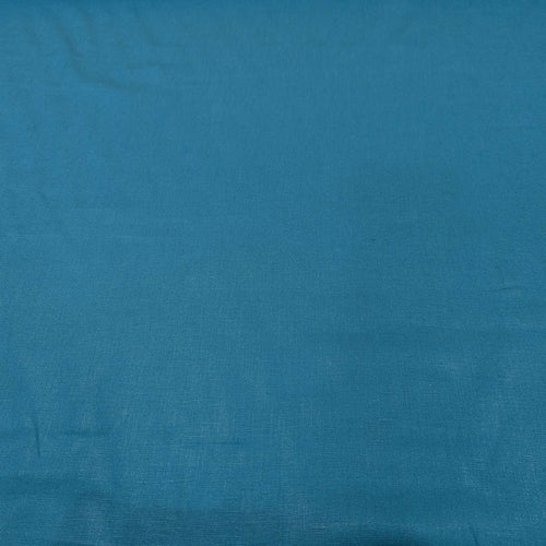 Flat lay of pure flax linen in petrol. Available at Minerva's Bower