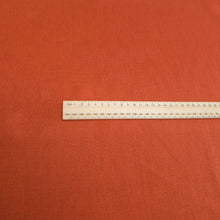 Load image into Gallery viewer, Flat lay of 100% heavyweight linen in rusty orange for sale at Minerva&#39;s Bower, ruler included for scale