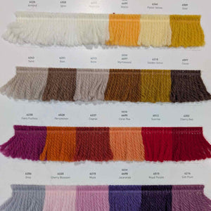 Color swatches of knitted fabric in various colors on a white background
