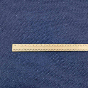Flat lay of Japanese pure textured wool Moss, in indigo colourway. Available at Minerva's Bower. Ruler included for scale
