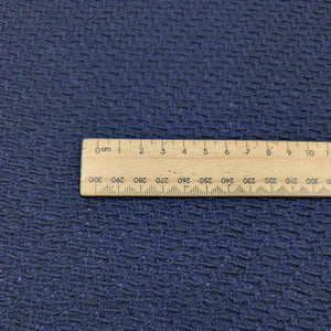 Flat lay of Japanese pure textured wool Moss, in indigo colourway. Available at Minerva's Bower. Ruler included for scale