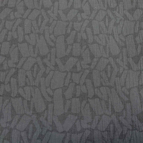 Textured black muno jacquard patterned fabric. Available at Minerva's Bower