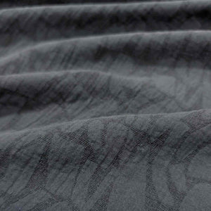 Close-up of textured black muno jacquard fabric with subtle pattern. Available at Minerva's Bower